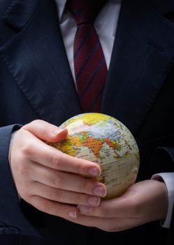 Businessman is standing with an earth globe fot business concept