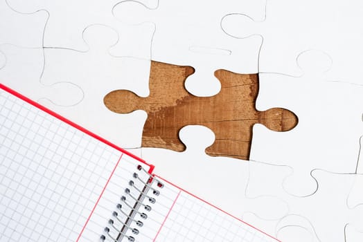 Building An Unfinished White Jigsaw Pattern Puzzle With Missing Last Piece