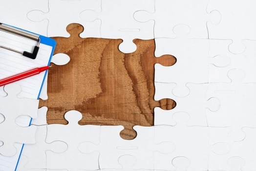 Building An Unfinished White Jigsaw Pattern Puzzle With Missing Last Piece