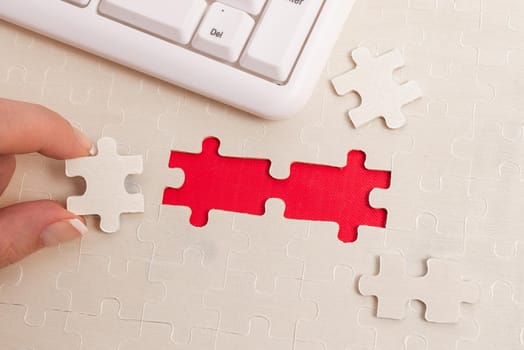 Building An Unfinished White Jigsaw Pattern Puzzle With Missing Last Piece