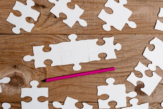 Building An Unfinished White Jigsaw Pattern Puzzle With Missing Last Piece