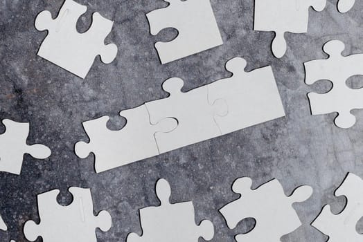 Building An Unfinished White Jigsaw Pattern Puzzle With Missing Last Piece