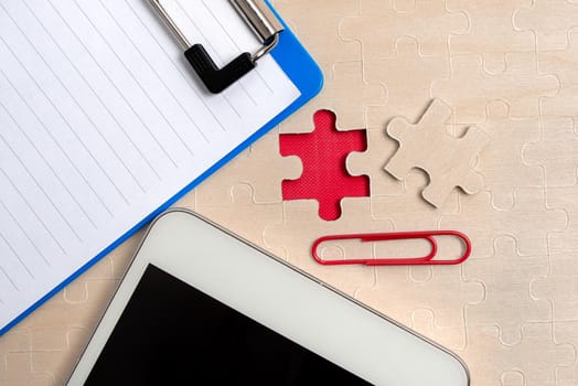 Building An Unfinished White Jigsaw Pattern Puzzle With Missing Last Piece
