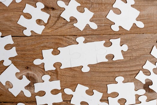 Building An Unfinished White Jigsaw Pattern Puzzle With Missing Last Piece