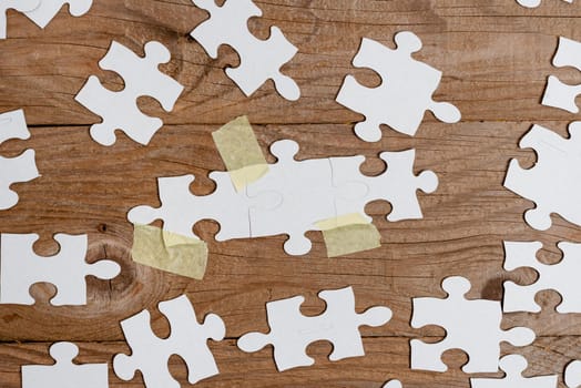 Building An Unfinished White Jigsaw Pattern Puzzle With Missing Last Piece