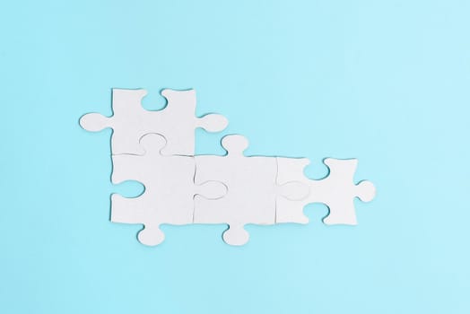 Building An Unfinished White Jigsaw Pattern Puzzle With Missing Last Piece