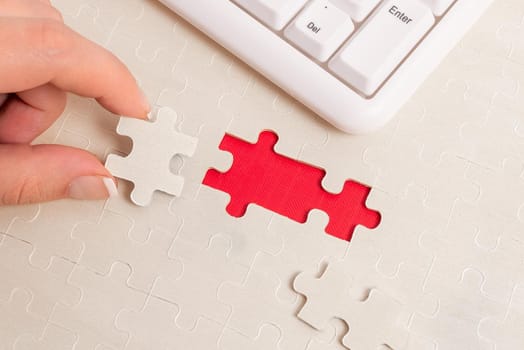 Building An Unfinished White Jigsaw Pattern Puzzle With Missing Last Piece