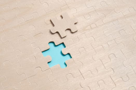 Building An Unfinished White Jigsaw Pattern Puzzle With Missing Last Piece