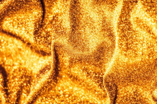 Luxe glowing texture, night club branding and New Years party concept - Golden holiday sparkling glitter abstract background, luxury shiny fabric material for glamour design and festive invitation