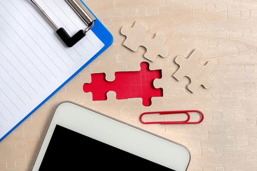 Building An Unfinished White Jigsaw Pattern Puzzle With Missing Last Piece