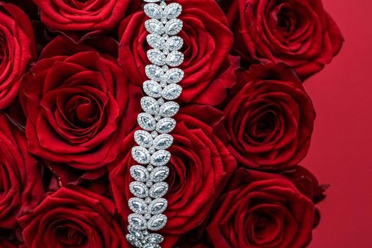 Gemstone jewellery, wedding fashion and luxe shopping concept - Luxury diamond bracelet and bouquet of red roses, jewelry love gift on Valentines Day and romantic holidays present