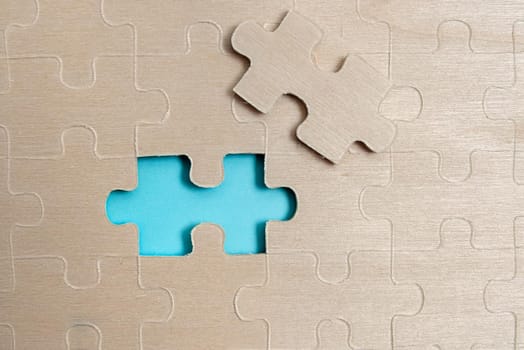 Building An Unfinished White Jigsaw Pattern Puzzle With Missing Last Piece