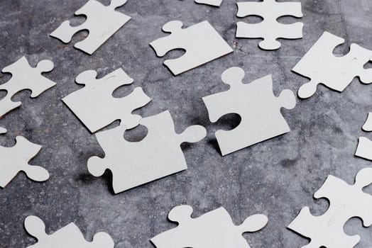 Building An Unfinished White Jigsaw Pattern Puzzle With Missing Last Piece