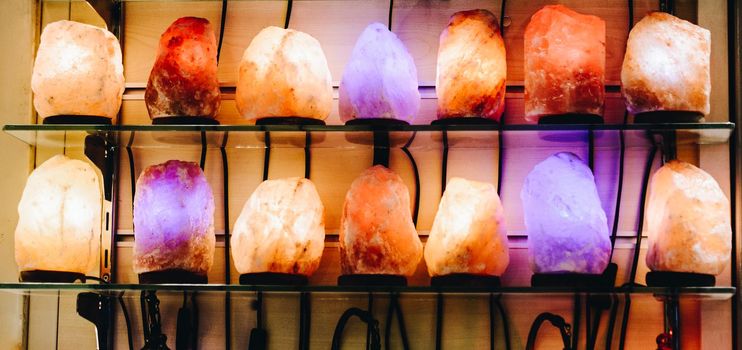 Organic Himalayan salt lamps illuminate in multi colors