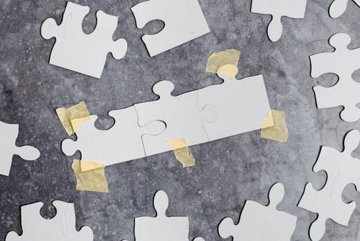 Building An Unfinished White Jigsaw Pattern Puzzle With Missing Last Piece