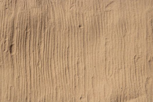 The print of the stripes on the sand from the recreation mat.