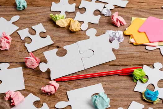 Building An Unfinished White Jigsaw Pattern Puzzle With Missing Last Piece