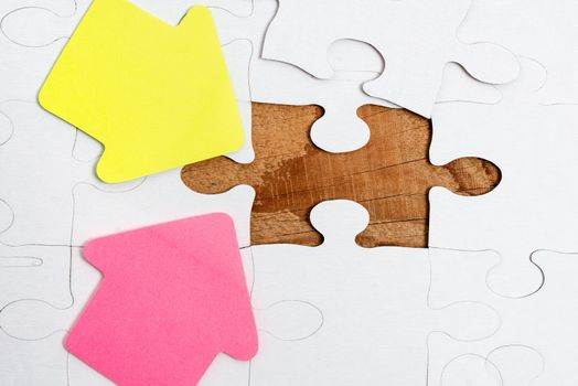 Building An Unfinished White Jigsaw Pattern Puzzle With Missing Last Piece