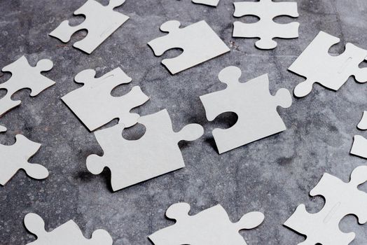 Building An Unfinished White Jigsaw Pattern Puzzle With Missing Last Piece