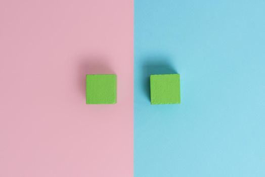 Two Objects Arranged Facing Inward Outward On a Separated Coloured Background