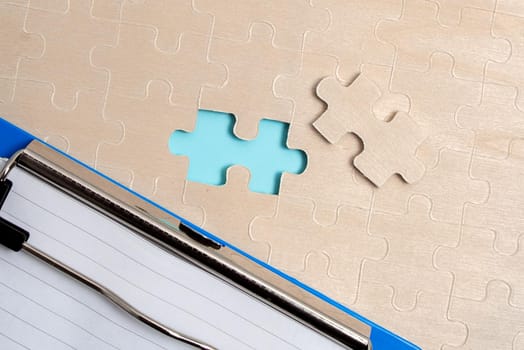 Building An Unfinished White Jigsaw Pattern Puzzle With Missing Last Piece
