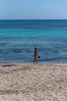 Formentera, Spain: June 12, 2021: People on Migjorn beach in Formentera in Spain in Times of COvid 19