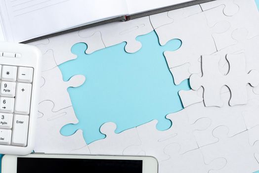 Building An Unfinished White Jigsaw Pattern Puzzle With Missing Last Piece