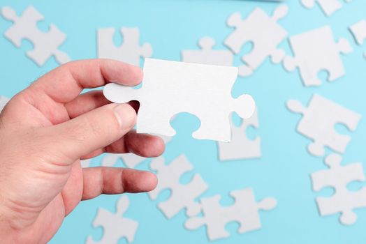 Building An Unfinished White Jigsaw Pattern Puzzle With Missing Last Piece