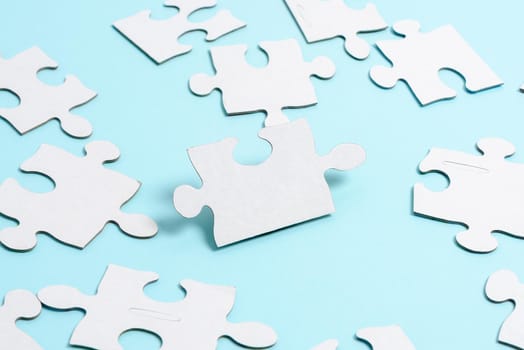 Building An Unfinished White Jigsaw Pattern Puzzle With Missing Last Piece