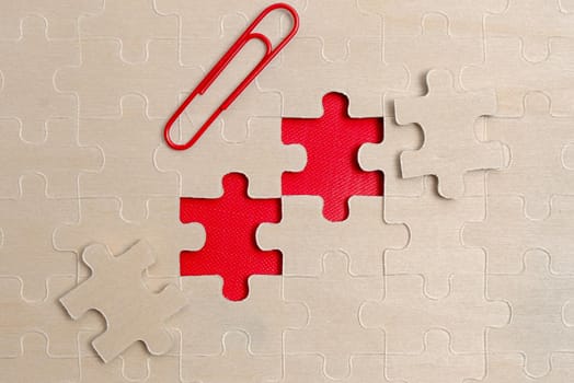 Building An Unfinished White Jigsaw Pattern Puzzle With Missing Last Piece