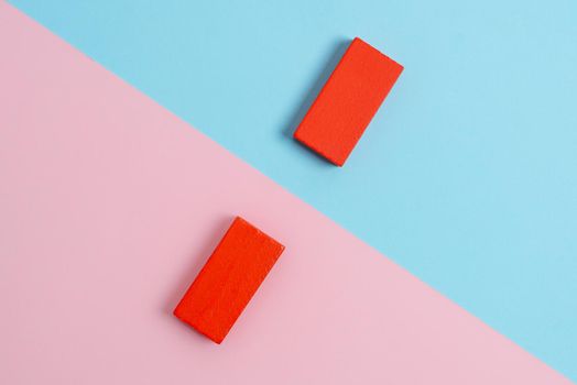 Two Objects Arranged Facing Inward Outward On a Separated Coloured Background