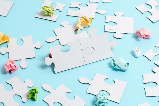 Building An Unfinished White Jigsaw Pattern Puzzle With Missing Last Piece