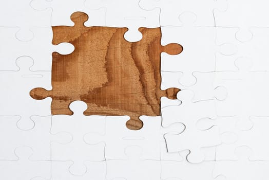 Building An Unfinished White Jigsaw Pattern Puzzle With Missing Last Piece