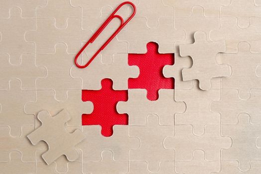 Building An Unfinished White Jigsaw Pattern Puzzle With Missing Last Piece