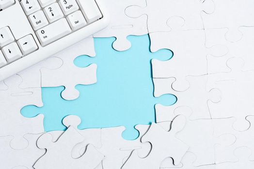 Building An Unfinished White Jigsaw Pattern Puzzle With Missing Last Piece