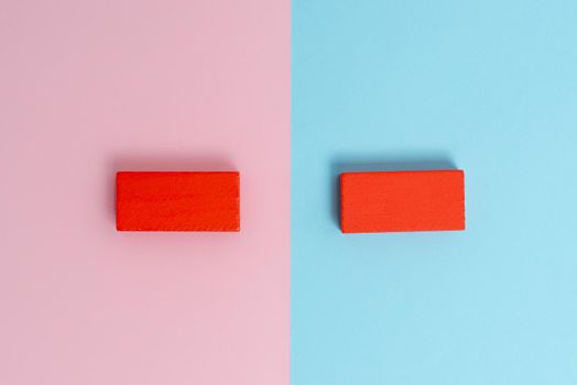 Two Objects Arranged Facing Inward Outward On a Separated Coloured Background