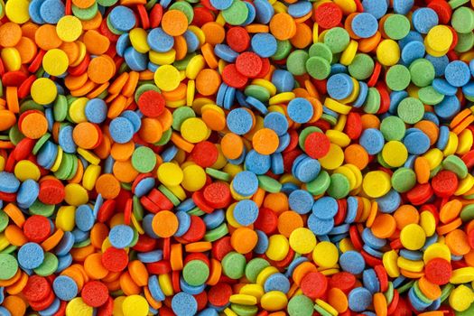 Rainbow sugar sprinkle dots, decoration for cake and bakery texture. Colorful Easter background. Confectionery multicolored decorative topping.