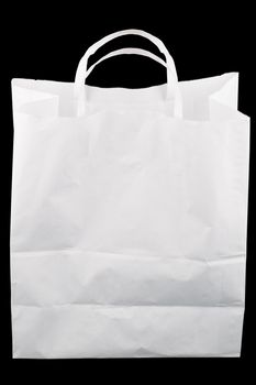 used white paper bag with handles isolated on black background.