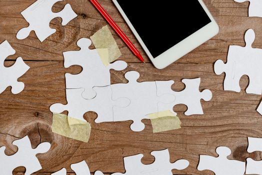 Building An Unfinished White Jigsaw Pattern Puzzle With Missing Last Piece