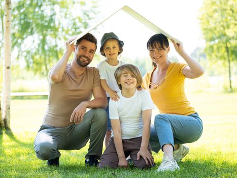 Family with roof over their heads as house construction real estate goal concept