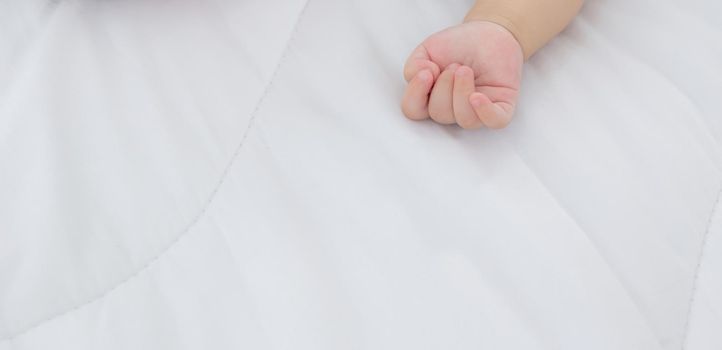 Portrait of asian little baby girl sleeping on bed in the bedroom at home, newborn napping with cozy and relax, infant innocence in bedtime, happy toddler cute, growth of child and emotion, indoors.