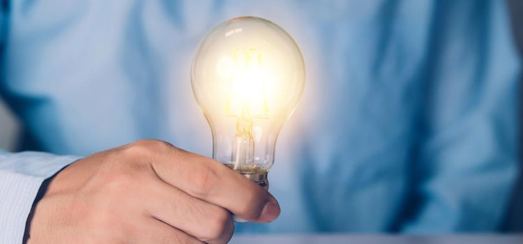 Businessman holding light bulb, imagination and intelligence, innovation and inspiration, brain symbol and solution and knowledge, creative idea and success, business and marketing concept.