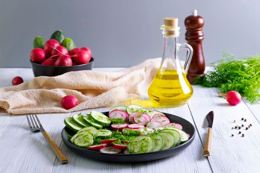 Fresh cucumber and radish salad with dill and vegetable oil. Vegetarian diet. Diesta for weight loss. Healthy eating. Selective focus.
