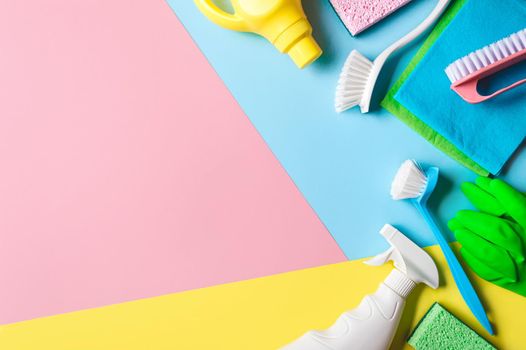 House cleaning product on pink background, copy space. Flat lay or top view. Cleaning service or housekeeping concept with space for text or design