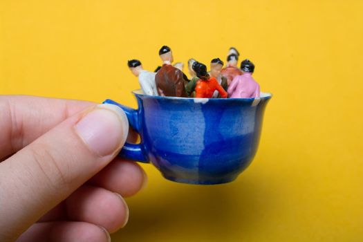 Miniature people business team standing on cup as business concept