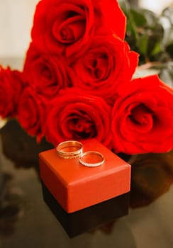 bridal bouquet of red roses with rings closeup. wedding concept
