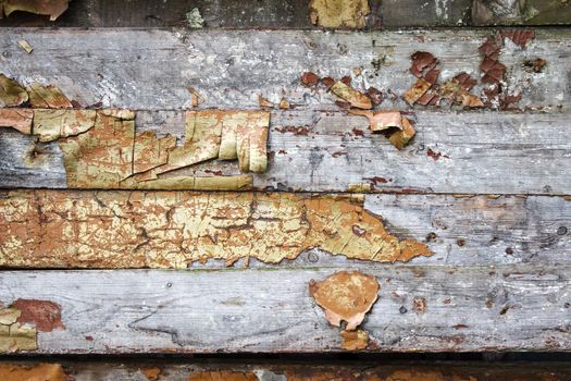 old plank wall with cracked paint. outdoor closeup. abstract background