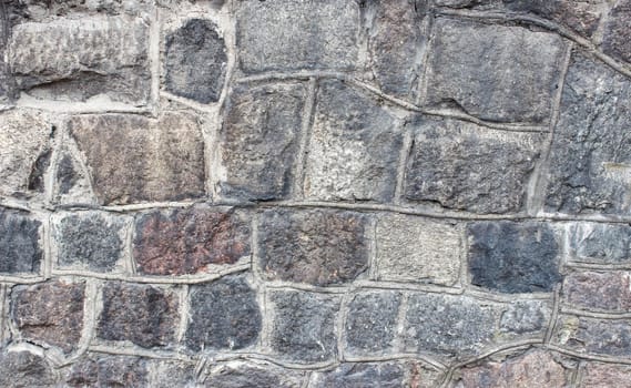 old wall of large stones outdoor closeup. abstract background