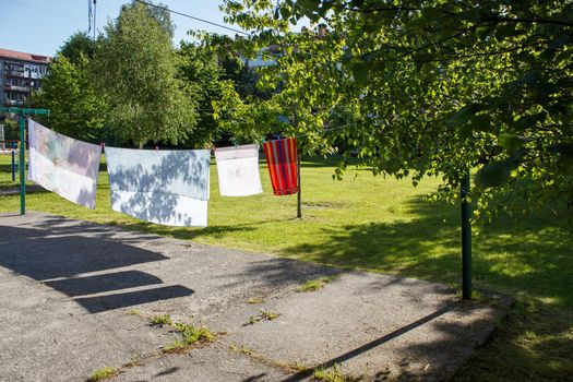 clothes dry on a rope in the yard on sunny summer day