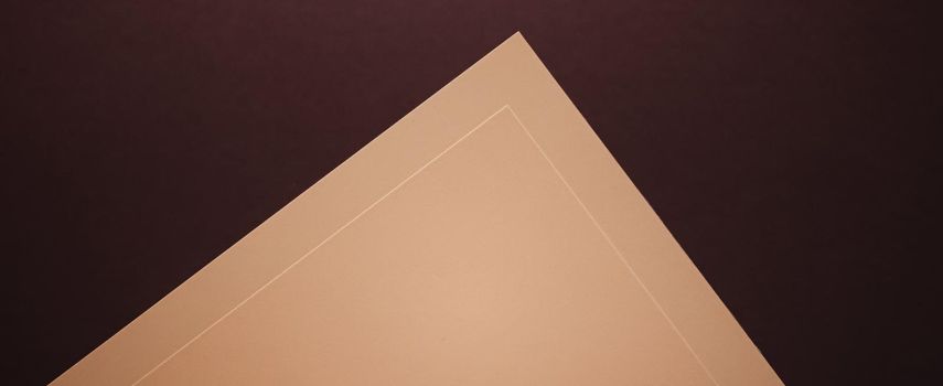 Blank A4 paper, beige on dark background as office stationery flatlay, luxury branding flat lay and brand identity design for mockups